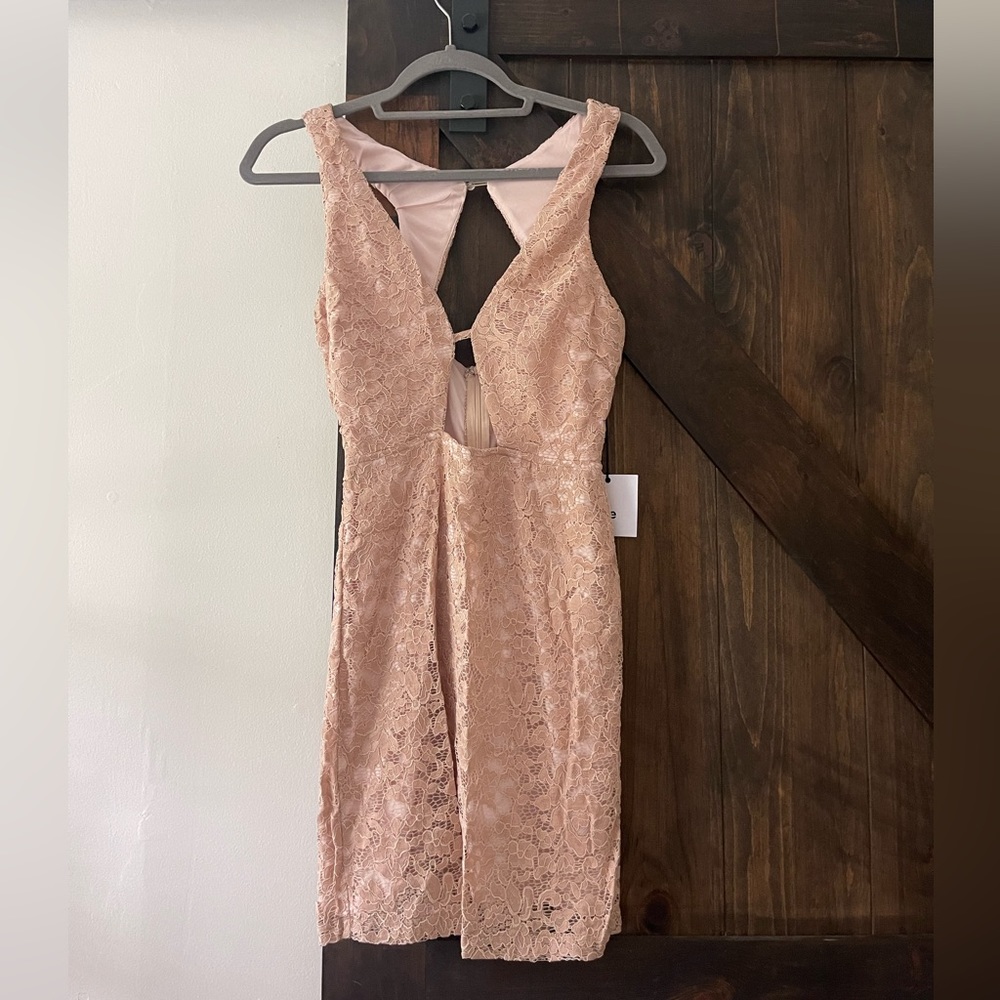 A peach/ cream beautiful laced dress with a fun back!